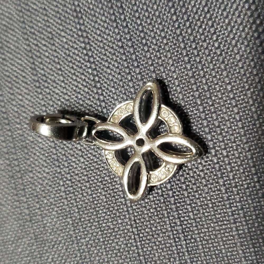 FOSSIL flower silvertone steel charm or pendant